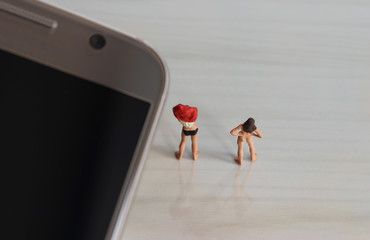 Miniature women. The concept of illegal movie shooting behavior.