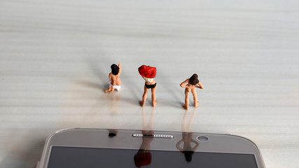 Miniature women. The concept is that illegal filming is a serious crime.