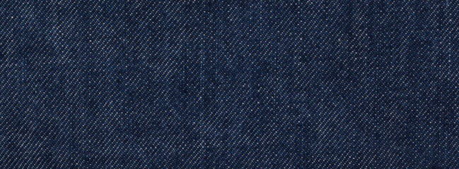 close up, macro shot of raw denim dark wash indigo blue jeans texture for banner background