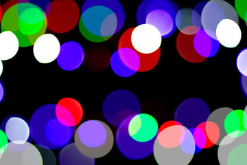 Multicolored bokeh on black background. Can be used as a background or wallpaper.