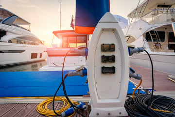 Charging station for boats, electrical outlets to charge ships in harbor. - 249250255