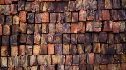 Texture of a brick colored wall, color bricks made in India.