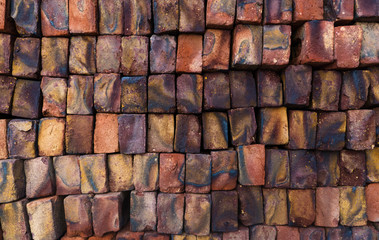 Texture of a brick colored wall, color bricks made in India.
