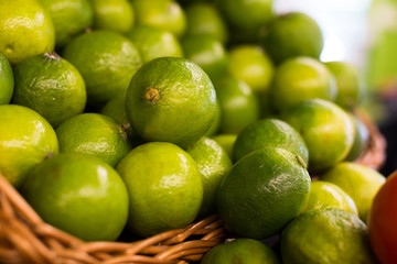 fresh limes in baskets on counter