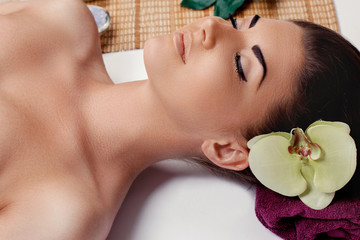 Spa Body Massage Treatment and Skin Care.Portrait of Young Beautiful Woman in Spa Salon.Leisure.Young female with clean fresh skin. Face Massage Female. Facial treatment. Cosmetology. Body care girl