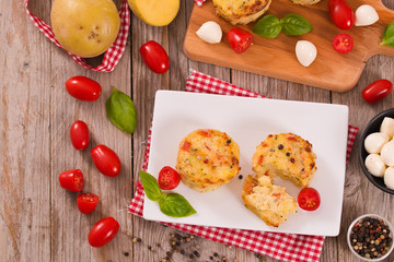 Potato gratins with mozzarella and tomatoes.