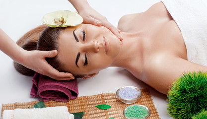 Obraz na płótnie Canvas Young pretty woman enjoying face massage procedure.Relaxing