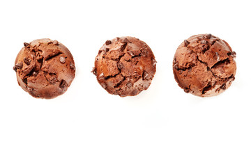 An overhead photo of three chocolate muffins, shot from the top on a white background with a place for text