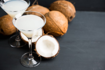 Sweet coconut cocktail in martini glass on the wooden background. Selective focus. Shallow depth of field. 