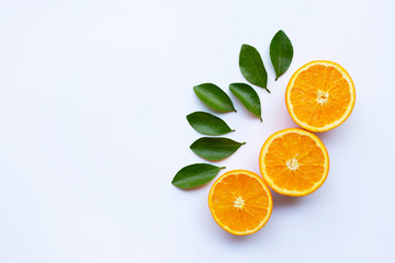 High vitamin C. Fresh orange citrus fruit with leaves isolated on white.