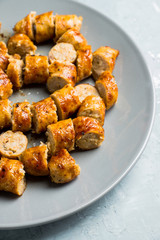 Grilled sliced sausages on plate with classic mustard sauce. Selective focus. Shallow depth of field. 