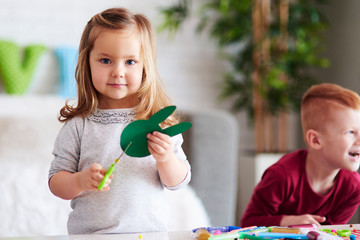Cute girl preparing decorations for Easter