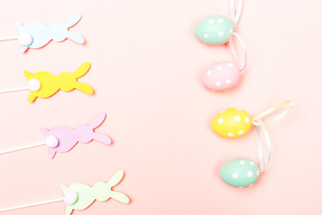Easter bunnies on pastel pink background