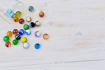 marbles on white wooden background