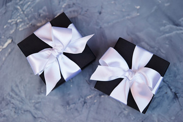 Black gift box with white ribbon 