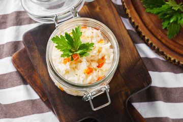 Jar of steamed or boiled rice with bell pepper or paprika.