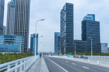 road through the bridge with city skyline background.