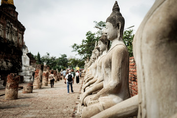 Fototapeta na wymiar Old stone beautiful image buddha in temple asian history in Ayutthaya, Thailand 