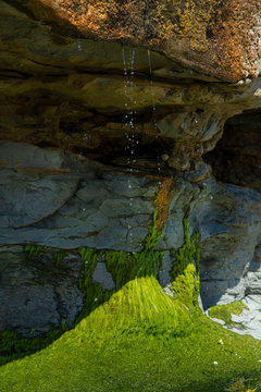 Waterdrops dripping. Rocks and cliffs at Farewell Spit Beach. Westcoast New Zealand