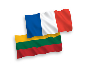 National vector fabric wave flags of France and Lithuania isolated on white background. 1 to 2 proportion.