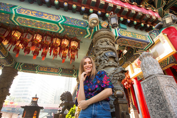 Fototapeta na wymiar Beautiful girl posing near old temple