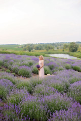 Pretty girl in a lavender field .