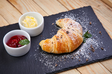 croissant with butter and jam