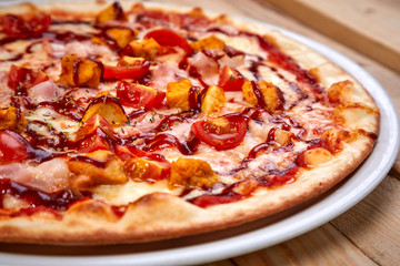 tasty pizza on the wooden background