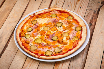 tasty pizza on the wooden background