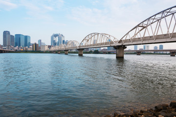 Fototapeta na wymiar Landscape of osaka city at Umeda from across the Yodogawa River.