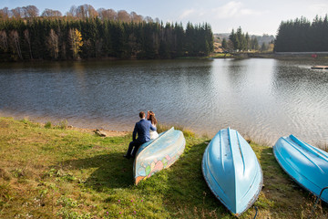 Young wedding couple posing outdoor near lake