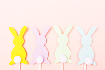 Easter bunnies on pastel pink background