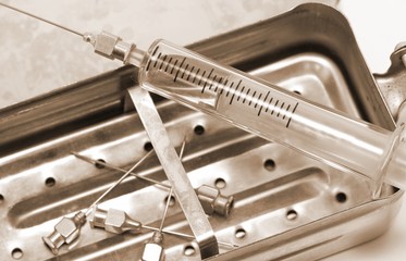 old syringe in glass material with vintage sepia effect