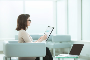 businesswoman checking financial documents in the workplace