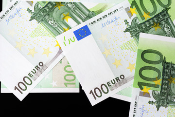One Hundred euro banknotes on a dark background close up