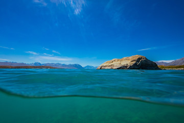half over half under the water surface at lake tekapo in New Zealand, over and under the lake takepo, Lake Tekapo, South Island, New Zealand 