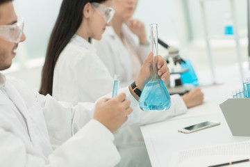 Fototapeta premium group of scientists conduct research liquid in a test tube