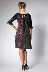 Blonde woman posing in long dress with flowers design