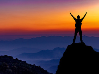 Silhouette of hiker man on top of mountain. successful people concept