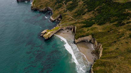 aerial photography of tunnel beach in New Zealand, DUNEDIN, NEW ZEALAND Tunnel beach, Dunedin, South island of New Zealand, amazing coast line from above with a drone, Cliff formations at Tunnel Beach