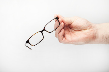 Male hand holds glasses