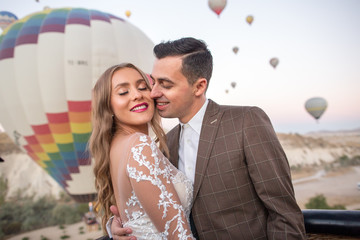 Beautiful wedding couple posing in front of hot air balloon