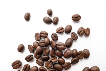 Roasted coffee beans isolated on white background. Close-up.
