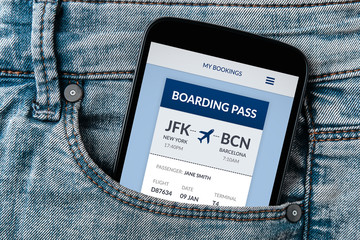Boarding pass concept on smartphone screen in jeans pocket