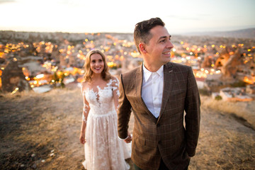 Beautiful wedding couple posing on peak near Cappadocia