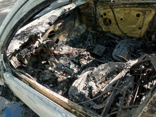 Fototapeta na wymiar Abandoned damaged and burnt out car