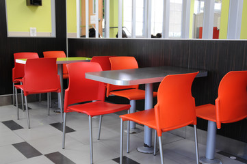 Red chairs and a table in a beautiful stylish interior