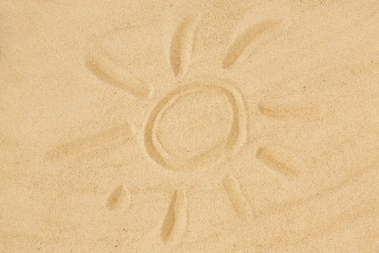 summer vacation concept - picture of sun in sand on beach
