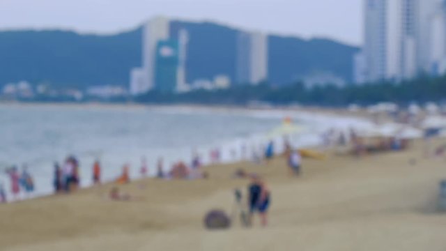 Blur, blurry, defocus panoramic view sand beach. Crowd people travel, tourists relax on the coastline. Nha Trang is the most popular destinations in Vietnam. Summer holiday vacation background blurred