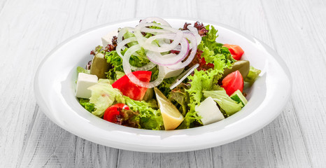 Fresh Greek salad in a bowl, top view